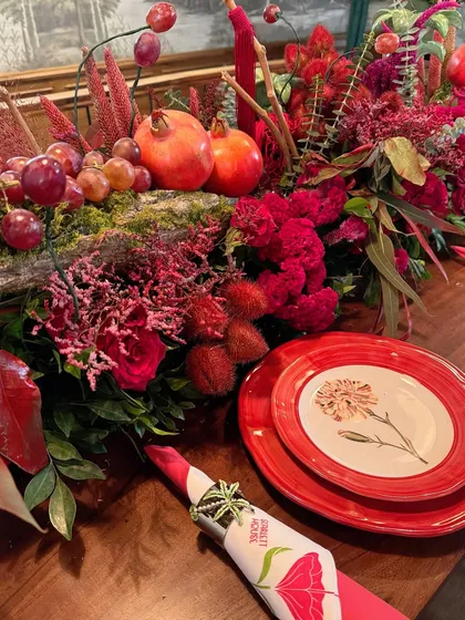 A detailed place setting from the Scarlett House launch, with a custom napkin ring and beautiful floral-patterned plates.