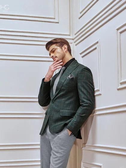 A thoughtful moment in the green checked suit. The unique color palette and classic pattern make it a sophisticated choice for making a statement in a professional setting.