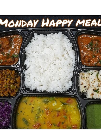 A wholesome Monday Happy Meal with dudhi kofta curry, rice, dal with radish, capsicum sabzi, white dhokla, and a fresh cabbage salad.