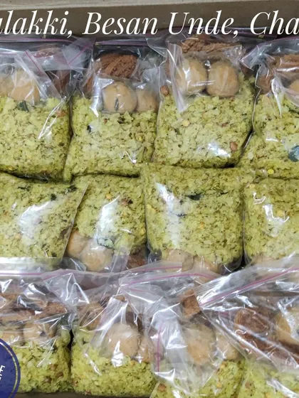 We take care in packaging your orders to ensure freshness. Here are neatly packed bags of savory Avalakki, sweet Besan Unde, and crispy Chakli prepared for a family's religious function.