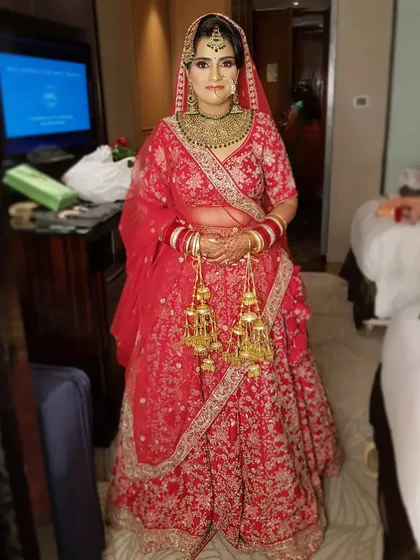 The full look for my bride in her red lehenga. The makeup is balanced to look stunning from a distance, ensuring she is the center of attention.