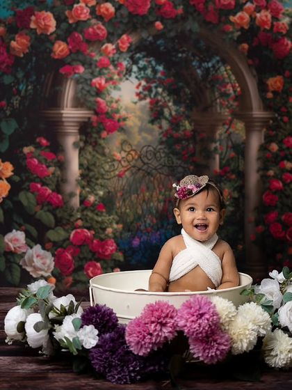 A beautiful, wide-angle shot showing the full floral bath setup against a romantic rose garden backdrop.