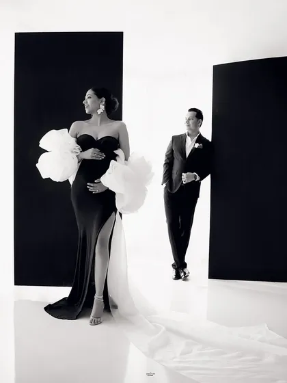 A dramatic and stylish black and white portrait. The composition, with the mamma in the foreground and her partner in the back, creates a cool, editorial feel.