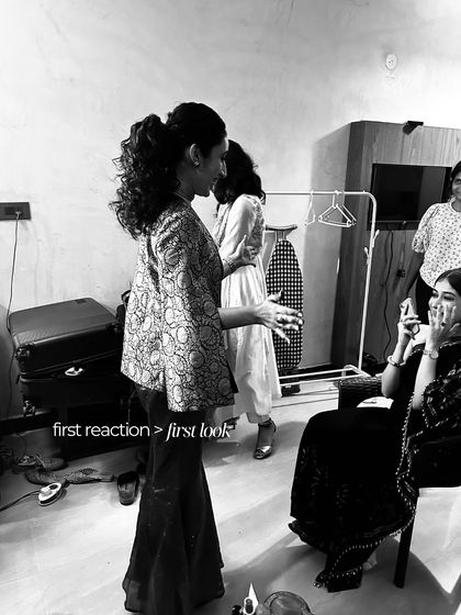 The first reaction is always more precious than the first look. A candid, black and white shot of the bride's sangeet look reveal.