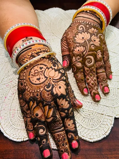 An elegant and traditional design perfect for any celebration. This piece combines beautiful lotus motifs with intricate patterns and is personalized with the client's partner's name, "Anil," inside a central mandala.