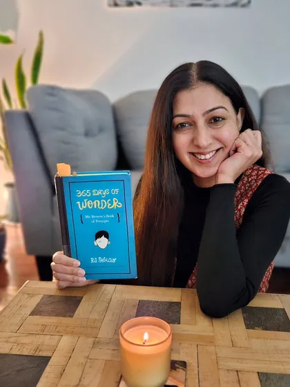 I believe in the power of wondering, pondering, and reflecting in writing. Here I am with the book '365 Days of Wonder,' which inspired me to start a weekly writing reflection with my community to spark 'aha' moments and self-discovery.