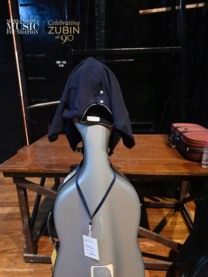 A quiet moment backstage. A musician's cello case rests near the stage, a silent testament to the dedication and preparation that goes into every single performance.