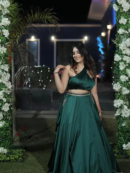 A side profile in the green gown, showing off the one-shoulder detail. I make sure to capture all the unique design elements of a garment.