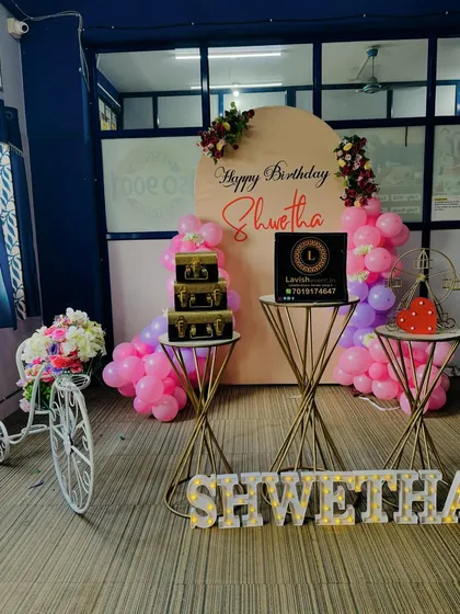 A slightly different composition of the 'Shwetha' birthday setup, showing the balance of the various decorative elements.