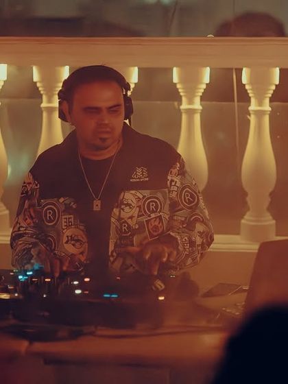 A shot of me at the decks during the NYE party, wearing a cool printed jacket.