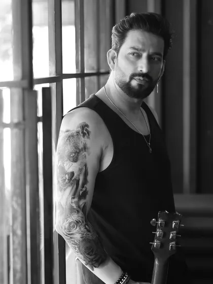 A black and white shot of Aadesh Chaudhary, showcasing his tattoos. This adds an edgy, modern vibe to his portfolio.
