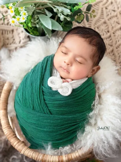 This little one is all bundled up in a beautiful emerald green wrap. Using rich, jewel-toned colors can create such a striking and memorable newborn portrait.