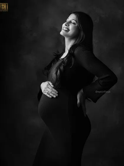 Pure, unfiltered emotion captured in a timeless black and white portrait. This image focuses on the sheer joy and radiance of the mom-to-be, proving that sometimes the simplest shots are the most powerful.