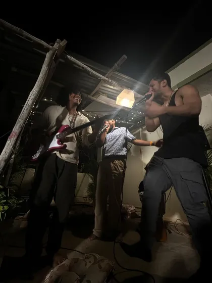 A different take on the rooftop jam, capturing the raw energy of the performance. The simple lighting and close quarters make for a powerful experience.