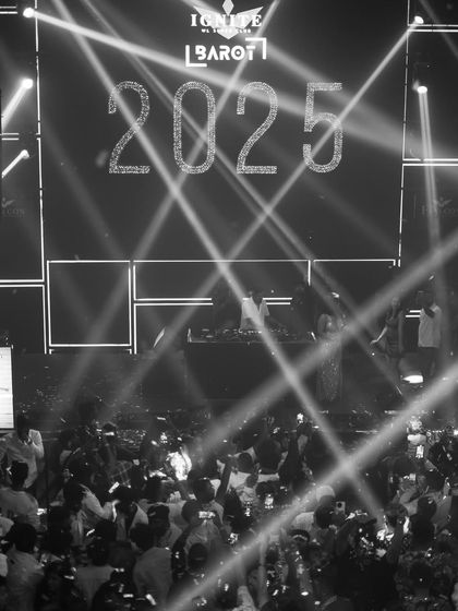 A black and white shot of the 2025 countdown. The dramatic lighting and massive screen created a powerful and timeless moment.