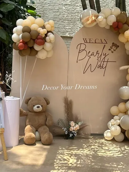 We also design modern, themed baby showers. This "We Can Bearly Wait" setup uses a neutral color palette with balloon arches and a custom backdrop for a chic and adorable celebration.