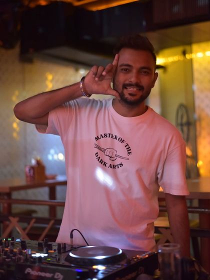 A confident pose behind the Pioneer DJ setup. This is me, ready to take control of the night and create an opportunity for a great time.