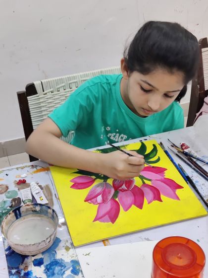 Watch the step-by-step process as a student paints a bright and cheerful bouquet of tulips on a yellow background.