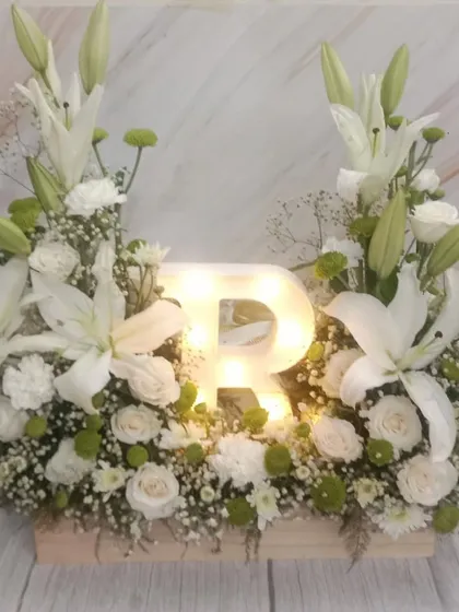 A stunning floral arrangement with a light-up initial, a beautiful and personalized gift for Mother's Day or any special occasion.