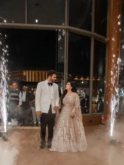 A grand entrance for the engaged couple, complete with sparklers and smoke, creating a cinematic and celebratory atmosphere.