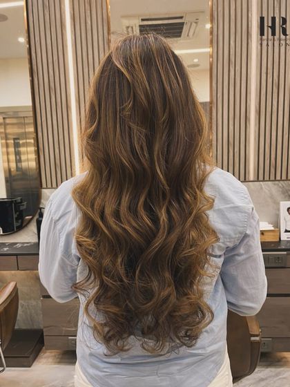 This look features soft, blended highlights on long hair, creating a very natural and sophisticated style.