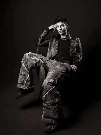 A relaxed, confident pose in a black and white studio setting that screams street style. The oversized jeans and leather jacket create a timeless, cool look.