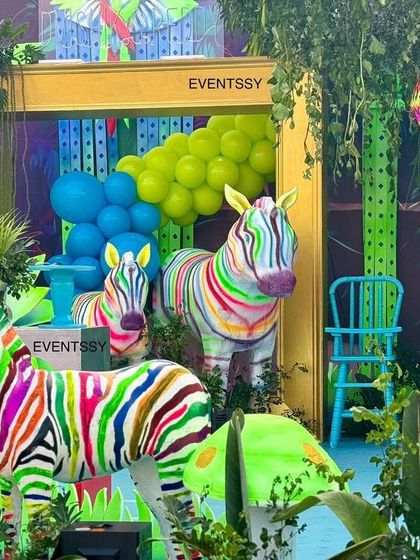 Another view of the rainbow zebras and hanging monkey piñata, highlighting the fun and interactive elements.