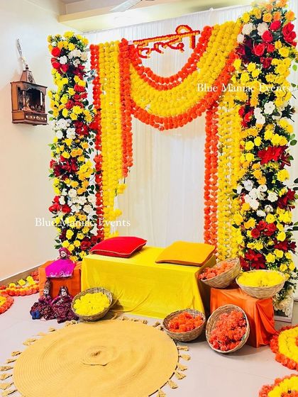 Another angle of the Haldi setup, highlighting the floor decor with flower baskets and a traditional rug.