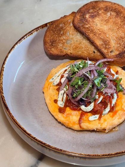 An overhead shot of our Balkan-style eggs, served with perfectly toasted bread for dipping.