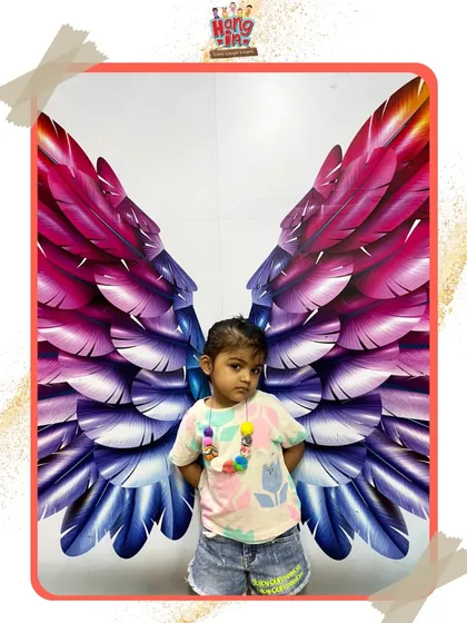 Another little one feeling shy but sweet in front of the colorful wings. We create a comfortable space for children of all personalities to express themselves.