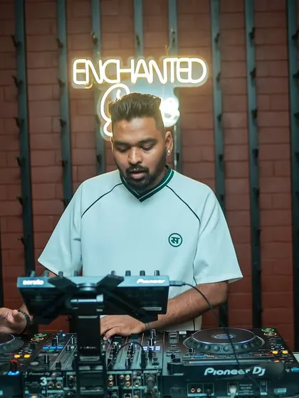 A clean shot of me at the console at 'Enchanted Grove'. The neon sign and brick wall create a cool, urban vibe.