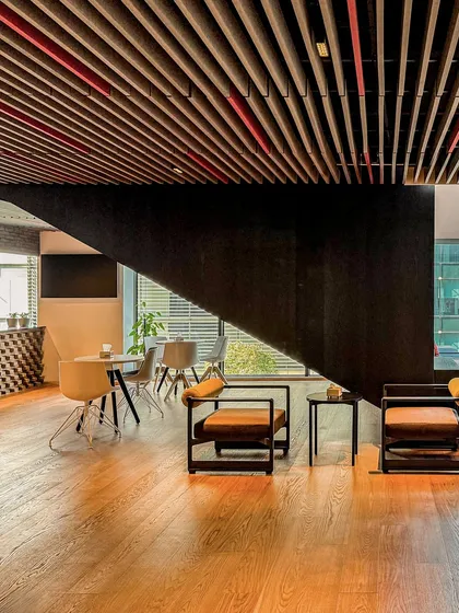 A lounge area at BCG HQ with comfortable seating and warm wooden floors, providing a relaxed alternative to a traditional desk setup.