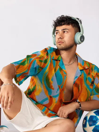 Another portrait with the headphones, focusing on the vibrant colors of the shirt. This is a great look for anyone wanting to add some personality to their summer wardrobe.