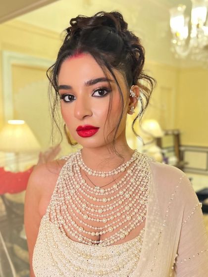 A portrait of the bride, her modern updo adding a fashionable edge to her reception look.