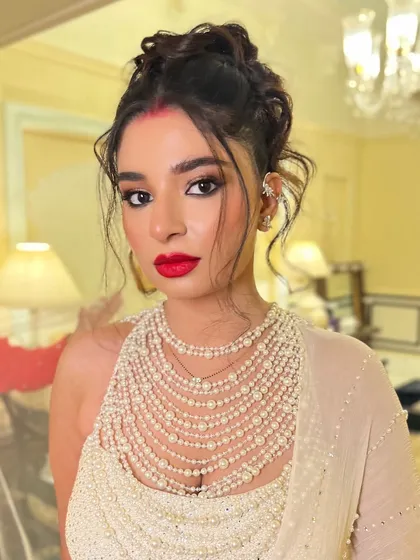 A portrait of the bride, her modern updo adding a fashionable edge to her reception look.