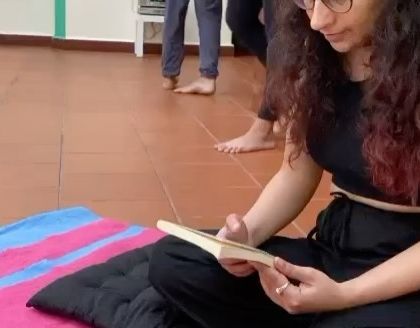 A close-up of a participant reading during a session. I encourage moments of quiet introspection as part of the overall wellness experience.