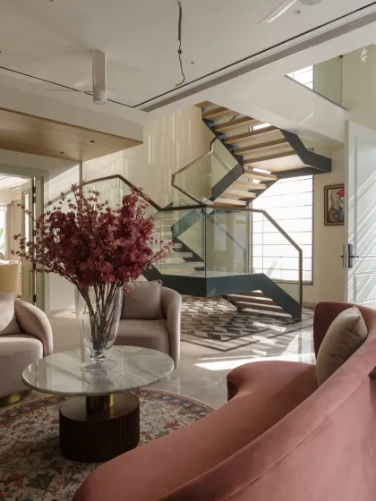 This view from the foyer looks towards the sculptural staircase, showing how we design open, flowing spaces where each area is connected yet distinct.