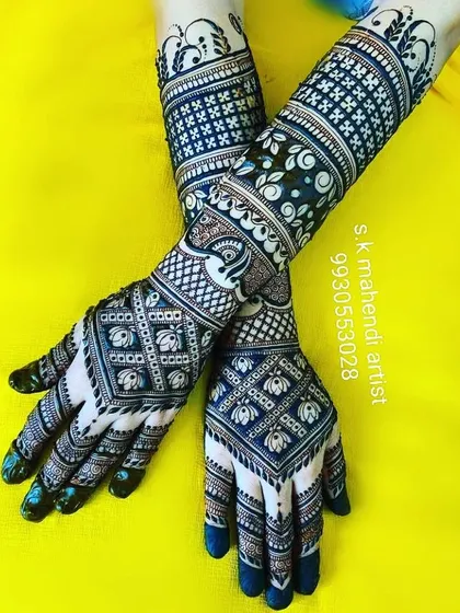 A modern geometric design using dark henna for a bold effect. The pattern consists of repeating blocks and checks, creating a very contemporary look.