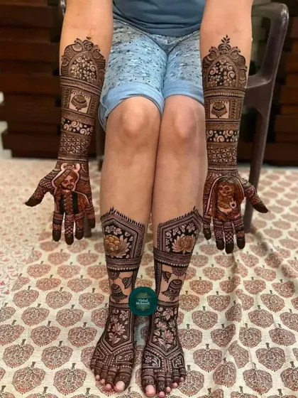 A complete bridal look with matching portrait mehandi on the hands and intricate floral and lotus designs on the feet.