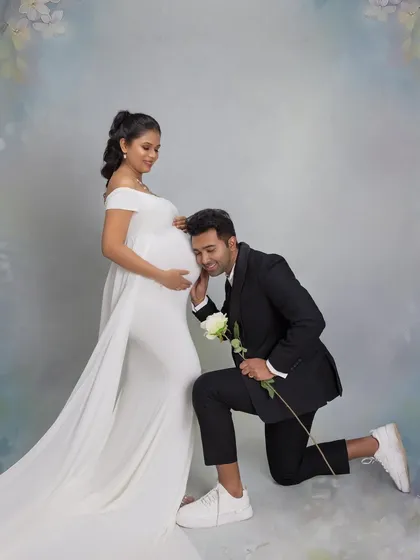 The dad-to-be listens in on his twins. This pose is twice as sweet when you're expecting two.