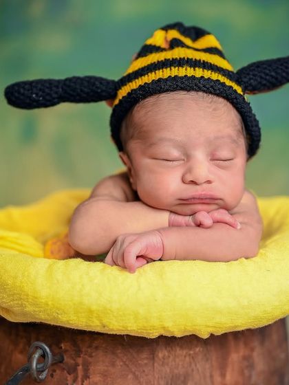 A close-up of the 'honey bee' theme, focusing on the baby's sweet, sleeping face.