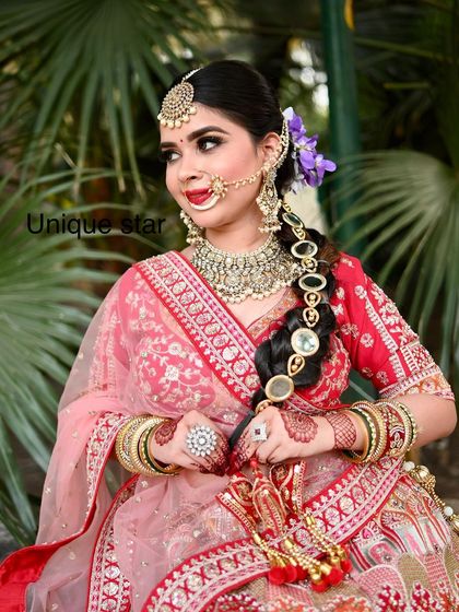 Another gorgeous shot of the model in our red and pink lehenga, showcasing the complete look from a different angle.