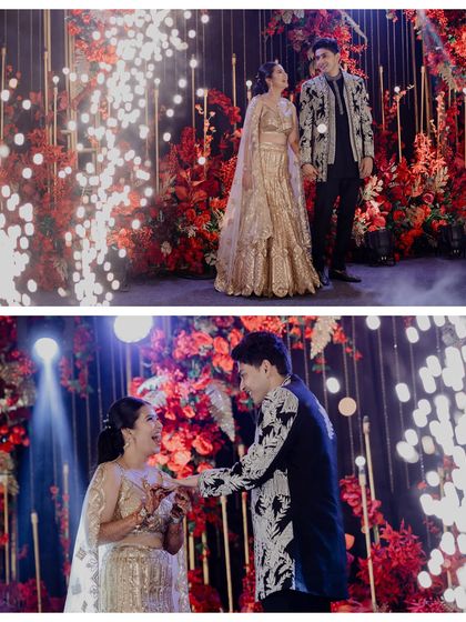 The ring exchange during the Sangeet, made even more magical with a backdrop of red flowers and sparklers.
