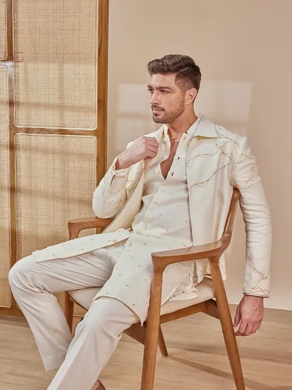 A relaxed pose in the full cream ensemble. This look is designed for comfort and style, allowing you to feel at ease during long hours of celebration.
