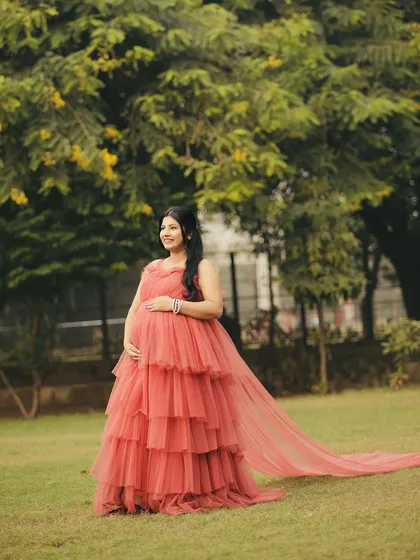 Look at this beautiful mom-to-be! Our flowy, tiered gown was the perfect choice for her maternity photoshoot. It’s comfortable, photographs beautifully, and is a wonderful way to celebrate this special time.
