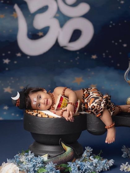 A serene portrait of a baby dressed as Lord Shiva, resting peacefully on a shivling.