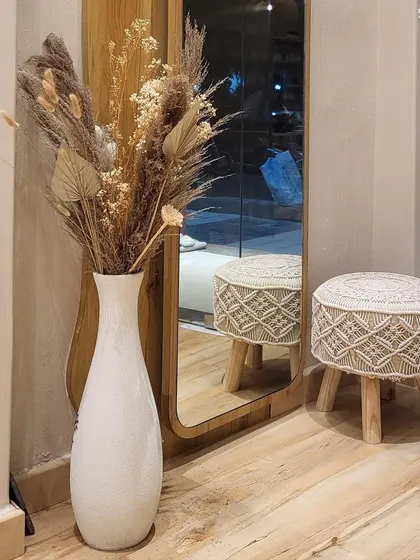 A quiet corner of the studio. The combination of natural textures, like this dried pampas grass arrangement, and modern decor creates a warm and inviting feel.