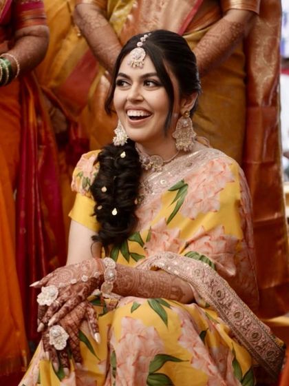 The happiest smiles are the best accessory. Simren's radiant joy is the centerpiece of her beautiful Haldi celebration.