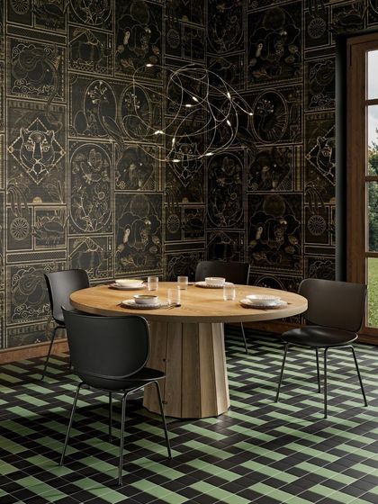 The Flock of Light, designed by Studio Toer, is suspended over a dining table like a swarm of fireflies frozen in time. Its delicate web of bronze wires and tiny LED sources creates a magical, dreamlike ambiance that is both modern and poetic.