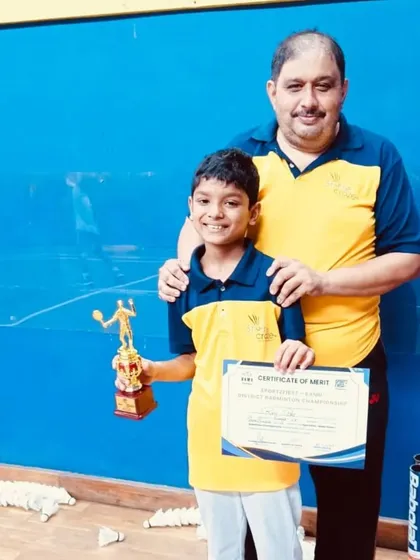 Rhys Pais with his coach, celebrating his runner-up position in the BS U13 category at the district championship.